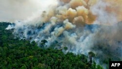 FILE - An aerial view of a burning area of Amazon rainforest reserve, south of Novo Progresso in Para state, Brazil, Aug. 16, 2020.