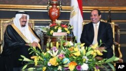 In this picture provided by the Office of the Egyptian Presidency, Egyptian President Abdel-Fattah el-Sissi, right, sits with Saudi Arabia's King Salman in the Abdeen Palace, Cairo, April 9, 2016. 