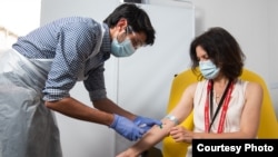In this undated photo from the University of Oxford, a volunteer received a coronavirus vaccine developed by AstraZeneca and Oxford University, in Oxford, England. (University of Oxford/John Cairns)