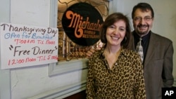 Michael and Ann Petrakis pose at the entrance to their Ohio restaurant in this 2009 photo. The Petrakis family serves free turkey dinners to those in need every Thanksgiving day.