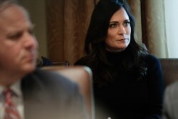 White House press secretary Stephanie Grisham listening to President Donald Trump during a Cabinet meeting in the Cabinet Room of the White House, Oct. 21, 2019.