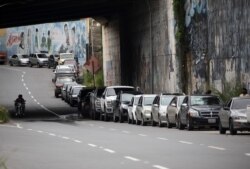 Vehicles line up near a gas station to fill their tanks in Caracas, Venezuela, Sept. 8, 2020.
