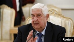 FILE - Syrian Foreign Minister Walid al-Moalem attends a meeting with his Russian counterpart Sergei Lavrov in Moscow, Russia, April 13, 2017.
