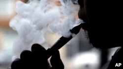 FILE - "Vape," according to the Oxford Dictionaries, is the verb that describes inhaling and exhaling the vapor from an electronic cigarette. It can also be a noun referring to the action or the device.