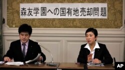 Opposition lawmakers Kiyomi Tsujimoto, right, and Masato Imai speak to reporters after visiting Osaka, western Japan, this week to investigate a scandal on a new elementary school in Tokyo, Feb. 23, 2017.