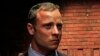 "Blade Runner" Oscar Pistorius awaits the start of court proceedings in the Pretoria Magistrates court, February 19, 2013.