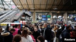 Passengers queue at the departure gates of the Eurostar terminal at Gare du Nord train station in Paris on Dec. 30, 2023, as flooding in a railway tunnel near London forced the cancellation of more than a dozen trains linking Britain with the European mainland.