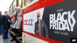 A woman gets off a tram advertising the Black Friday in Prague, Czech Republic, Nov. 28, 2019.