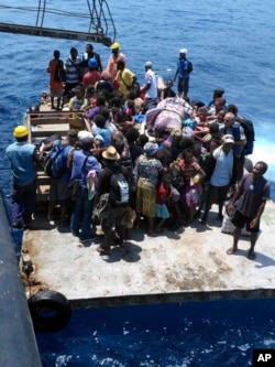 FILE - Residents wait on a raft to board a boat as they are evacuated from the Pacific island of Ambae, which is part of Vanuatu on Wednesday Sept. 27, 2017.