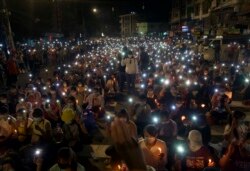 Anti-coup protesters turn on the LED light of their mobile phones during a candlelight night rally in Yangon, Myanmar Sunday, March 14, 2021.