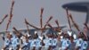 Indian Air Force soldiers toss their rifles during the full-dress rehearsal for Indian Air Force Day at the Hindon air force station on the outskirts of New Delhi.