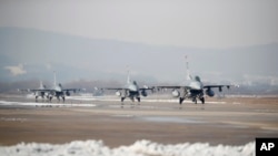 FILE - U.S. Air Force F-16 fighter jets take part in a joint aerial drills called Vigilant Ace between U.S and South Korea, at the Osan Air Base in Pyeongtaek, South Korea, Dec. 6, 2017.