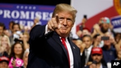 President Donald Trump arrives for a campaign rally at Florida State Fairgrounds Expo Hall in Tampa, Fla., July 31, 2018.