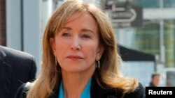 Actor Felicity Huffman, facing charges in a nationwide college admissions cheating scheme, enters federal court in Boston, Massachusetts, April 3, 2019.