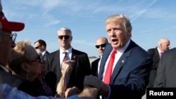 FILE - President Donald Trump greets well-wishers upon his arrival in West Palm Beach Florida, Feb. 17, 2017. 