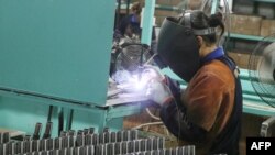This photo taken on June 9, 2020, shows an employee working at a factory in Haian in China's eastern Jiangsu province. China's factory-gate prices remained at four-year lows in May, official data showed on June 10.