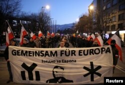 Members and supporters of several nationalist organizations take part in a march in commemoration of the late Gen. Hristo Lukov, a Bulgarian army commander, in Sofia, Bulgaria, Feb. 16, 2019. The banner reads "Together for Europe."
