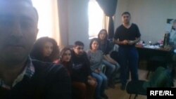RFE/RL's Baku bureau staff held as office raided by Azerbaijani prosecutors, Dec. 26, 2014.