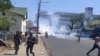 Protesters run from tear gas in Blantyre, Malawi, Nov. 19, 2021. (Lameck Masina/VOA)