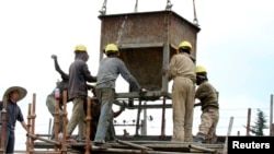 Laborers work at a railway station construction site in Ethiopia's capital Addis Ababa, Sept. 16, 2013.