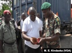 Military officials examine ammunition.