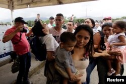 People cross the Colombian-Venezuelan border over the Simon Bolivar international bridge in Cucuta, Colombia, April 2, 2019.