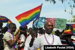 People who identified themselves as members of the lesbian, gay, bisexual and transgender (LGBT) community parade in Entebbe, southwest of Uganda's capital, Kampala, Aug. 8, 2015.