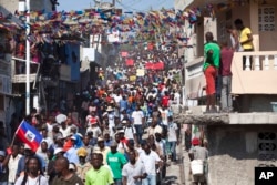 Protesters chant anti-government slogans during a protest against President Michele Martelly's government to demand the cancellation of the Jan. 24, elections, in Port-au-Prince, Haiti, Jan. 18, 2016.