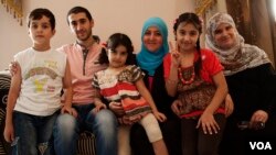 Syrian activist Soad Khadeya (third from right wearing a blue hijab) has opened her home near Cairo to other Syrian refugees, September 11, 2013. (Yuli Weeks for VOA)