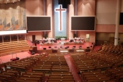 Public officials disinfect as a precaution against the coronavirus at the Yoido Full Gospel Church in Seoul, South Korea, Aug. 21, 2020.