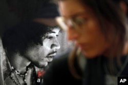 FILE - A photograph of late U.S. musician Jimi Hendrix decorates an office of the Handel House Museum, in what used to be the star's bedroom when he was living in the house during late 1960s, in central London's Mayfair area, Aug. 24, 2010.