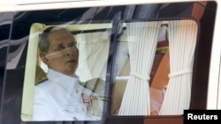 FILE - Thailand's King Bhumibol Adulyadej is seen sitting in a vehicle as he leaves Siriraj Hospital for the Grand Palace to join a ceremony marking Coronation Day in Bangkok, Thailand, May 5, 2015.
