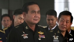 FILE - Thailand's Army commander Gen. Prayuth Chan-ocha, left, arrives at the Royal Thai Army Club in Bangkok, Thailand.