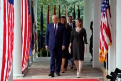 President Donald Trump walks along the Colonnade&nbsp;with Judge Amy Coney Barrett to a news conference to announce her as his nominee to the Supreme Court, at the White House, Sept. 26, 2020.