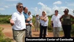 Youk Chhang, Elizabeth Becker and Michael ABRAMOWITZ, USHMM Director and his delegations at a B52 bomb pond near the Chinese airport, Kampong Chhnang province. Oct 24, 2012. Photo by Nhean Socheat.
