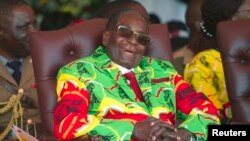 FILE - Zimbabwean President Robert Mugabe smiles during a youth rally in Marondera about 100 kilometers east of Harare, June, 2, 2017. 