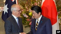 Australian Prime Minister Malcolm Turnbull, left, shakes hands with his Japanese counterpart Shinzo Abe prior to a meeting at Abe's official residence in Tokyo, Jan. 18, 2018. 