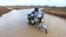 A motorcycle rider crosses a flooded section of the road in Hola, Kenya, on Nov. 7, 2023. Heavy rain and flooding killed 15 people in Kenya recently.