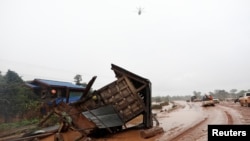 A military helicopter flies during the flood after the Xe Pian-Xe Namnoy hydropower dam collapsed in Attapeu province, Laos, July 26, 2018.