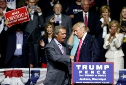 FILE - Then-Republican presidential candidate Donald Trump welcomes Nigel Farage, left, ex-leader of the British UKIP party, to speak at a campaign rally in Jackson, Miss., Aug. 24, 2016.