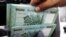 FILE - Lebanese pound banknotes are seen at a currency exchange shop in Beirut, Lebanon, June 15, 2020. 