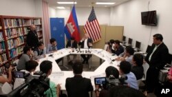 U.S. Ambassador to Cambodia William Heidt, rear center, gives a press conference at the U.S. Embassy in Phnom Penh, Cambodia, Tuesday, Sept. 12, 2017. Heidt has delivered a sharp response to allegations by Prime Minister Hun Sen that Washington is seeking to dislodge his government, denying the allegations and warning that Cambodia is doing itself damage international with its anti-American campaign. (AP Photo/Heng Sinith)