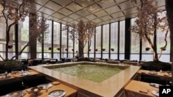 In this April 29, 2016 photo, spring blossoming trees adorn the Pool Room dining area of The Four Seasons restaurant, which opened in 1959 and closed in 2016. 