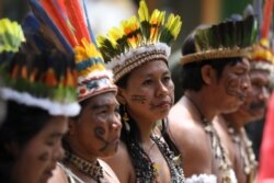 Representatives of the Huitoto and Ticuna indigenous communities wait whileleaders of several South American nations that share the Amazon are meeting, in Leticia, Colombia, Sept. 6, 2019.