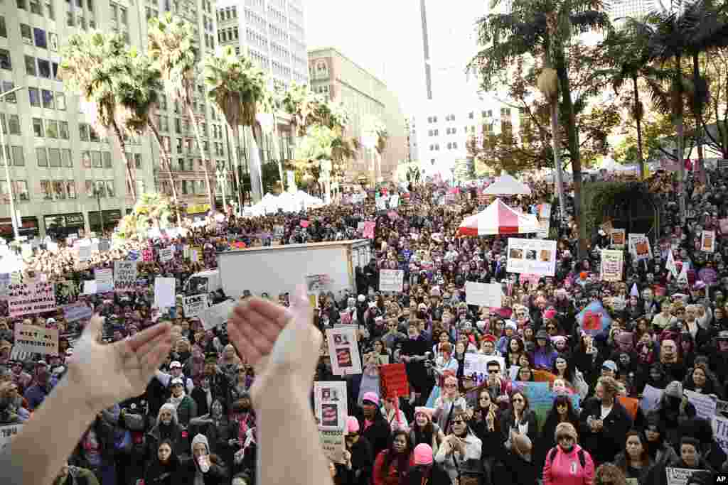 Protesters listen to a speaker as they gather for the Women&#39;s March against President Donald Trump, Jan. 21, 2017, in Los Angeles. (AP Photo/Jae C. Hong)