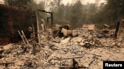 The debris of a burned home is seen after the Carr Fire west of Redding, Calif, July 28, 2018. 