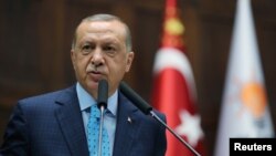 Turkish President Tayyip Erdogan addresses parliamentarians from his ruling AK Party during a meeting at the parliament in Ankara, Turkey, July 24, 2018.