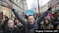 FILE - In this Sunday, Jan. 28, 2018 file photo, Russian opposition leader Alexei Navalny, center, attends a rally in Moscow, Russia. (AP Photo/Evgeny Feldman, File)