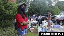 UConn sophomore Sahiti Bhyravavajhala assists students moving into Shippee Hall on the Storrs, Conn. campus, Friday, Aug. 27, 2021. UConn is one of many schools across the nation mandating that returning students be vaccinated against COVID-19.AP Photo/Pa