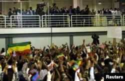 Eritrea's President Isaias Afwerki and Ethiopian Prime Minister Abiy Ahmed look at supporters as they attend a concert at the Millennium Hall in Addis Ababa, Ethiopia, July 15, 2018.